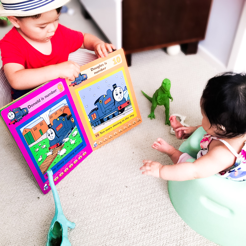 cute & little blog | family time | toddler brother reading book to baby sister
