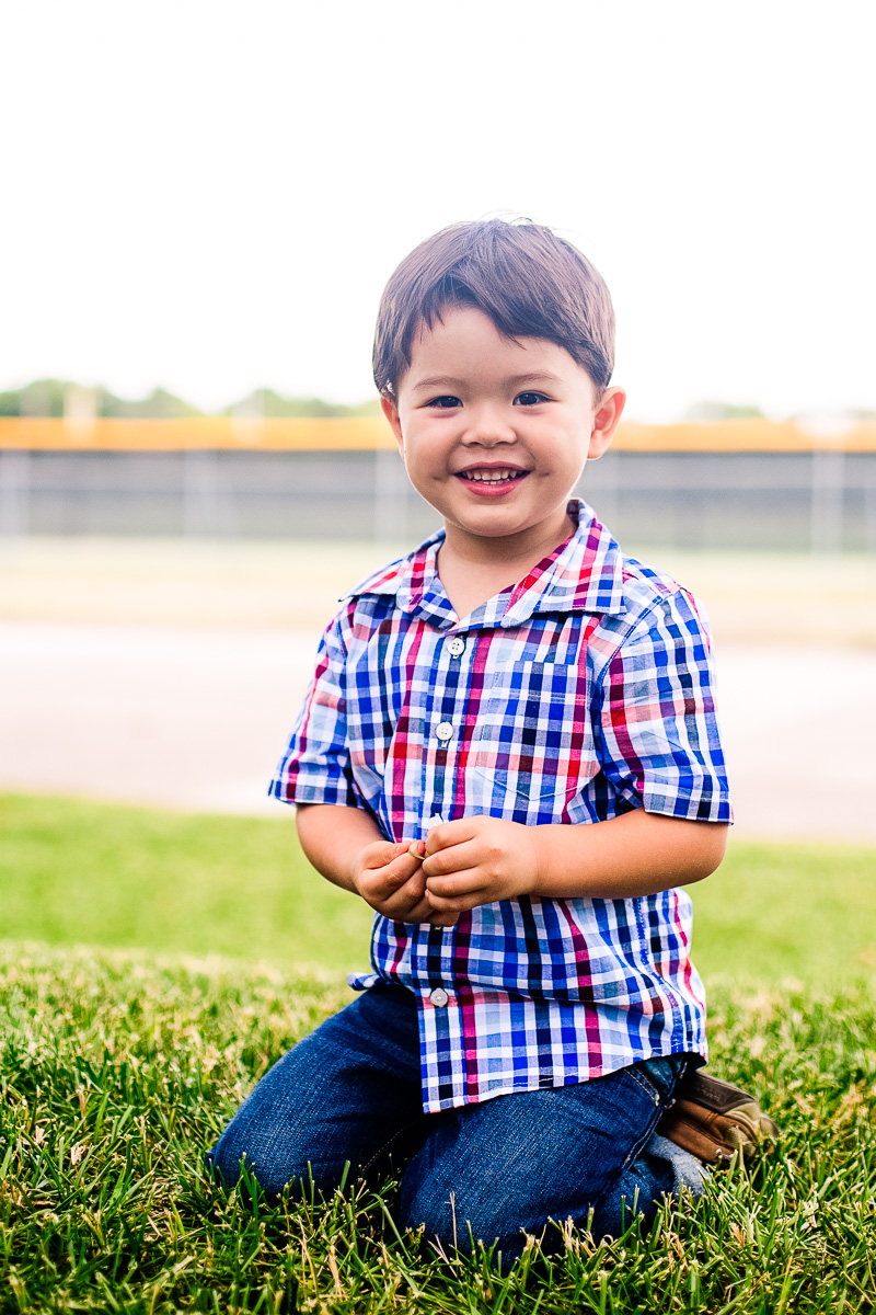 toddlery boy sitting on grass, plaid shirt, jeans, gap factory back to school fall outfit