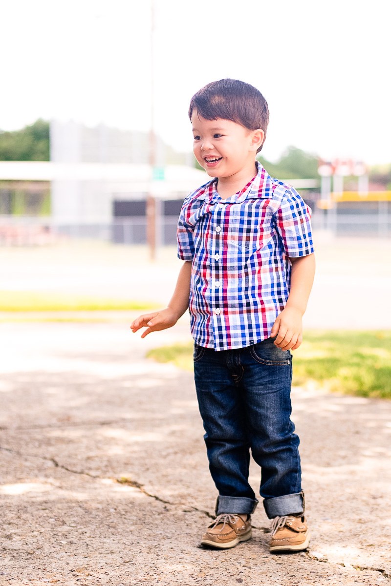 toddlery boy standing on sidewalk, plaid shirt, jeans, gap factory back to school fall outfit