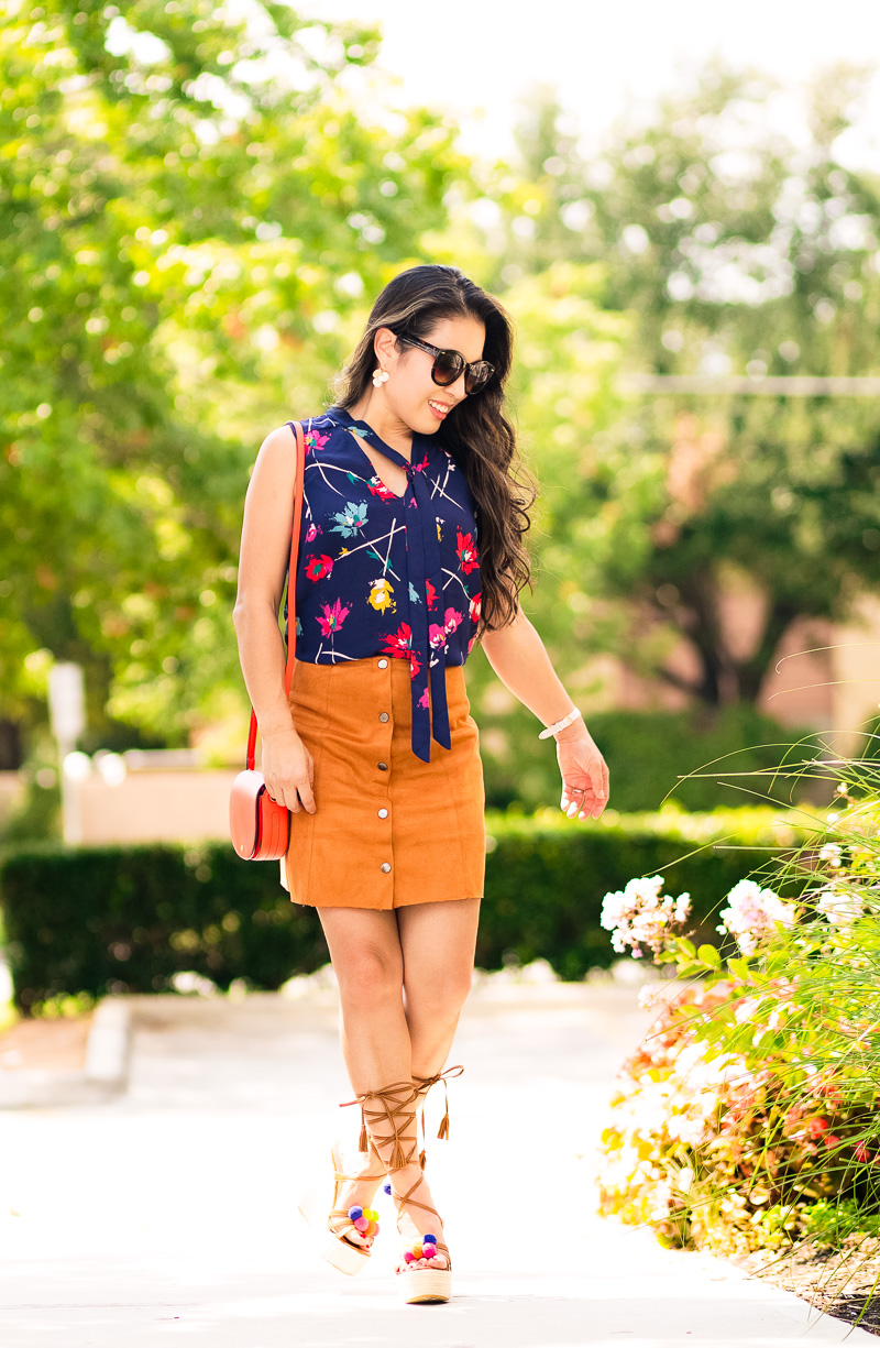 cute & little | petite fashion blog | navy floral tie blouse, suede button mini skirt, lace-up pom pom espadrille wedges, red saddle bag | summer fall transition outfit