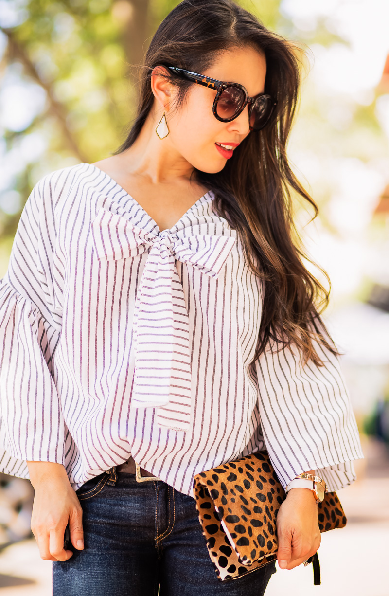 cute & little | petite fashion blog | striped bell sleeve bow top, kendra scott alex earrings, leopard clutch | summer fall outfit