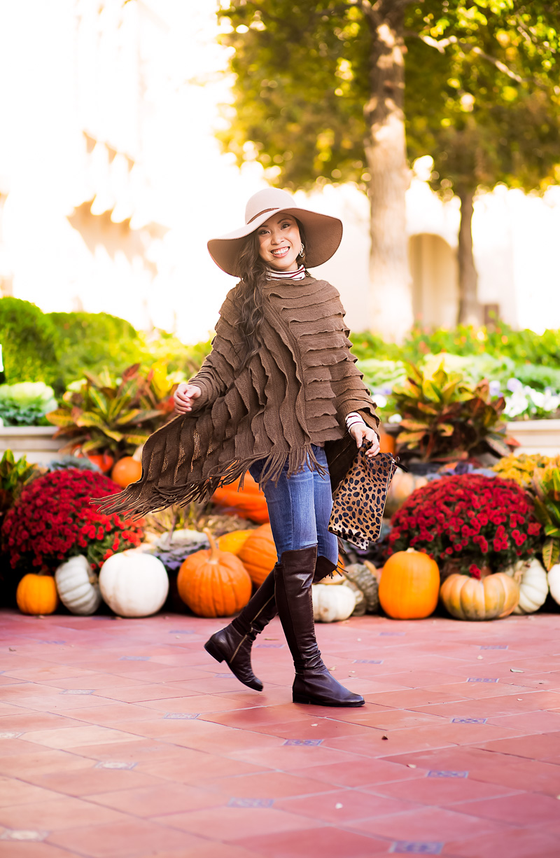 cute & little blog | petite fashion | layered poncho, distressed jeans, leather otk boots, wool floppy hat, leopard clutch | fall winter outfit