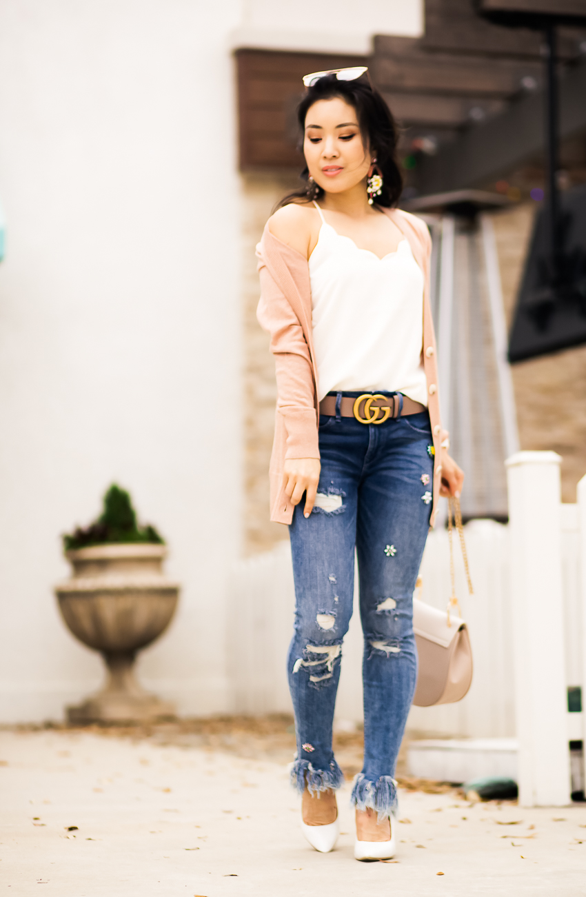 cute & little | dallas petite fashion blog | pink cardigan, scallop cami, express embellished fringe skinny jeans, gucci belt, statementn earrings | spring outfit - Raw Hem Jeans and All The Hem Details by popular Dallas petite fashion blogger cute & little