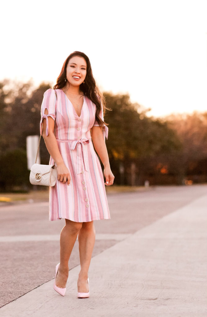 Valentine's Day Dress featured by top US fashion blog Cute & Little; Image of a woman wearing  Express Striped Button Dress, Express Layered Pave Charm Necklace, Louboutin 'Pigalle Follies' Pink Pumps, Baublebar 'Azalea' Flower Studs, Gucci Marmont Crossbody bag.
