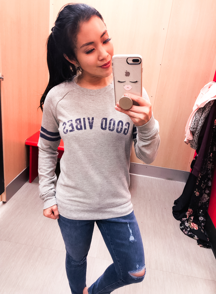 Shopping at Target featured by top US fashion blog Cute & Little; Image of a woman wearing Target Grayson Threads 'Good Vibes' Pullover and Target High Rise Crop Skinny Jeans.