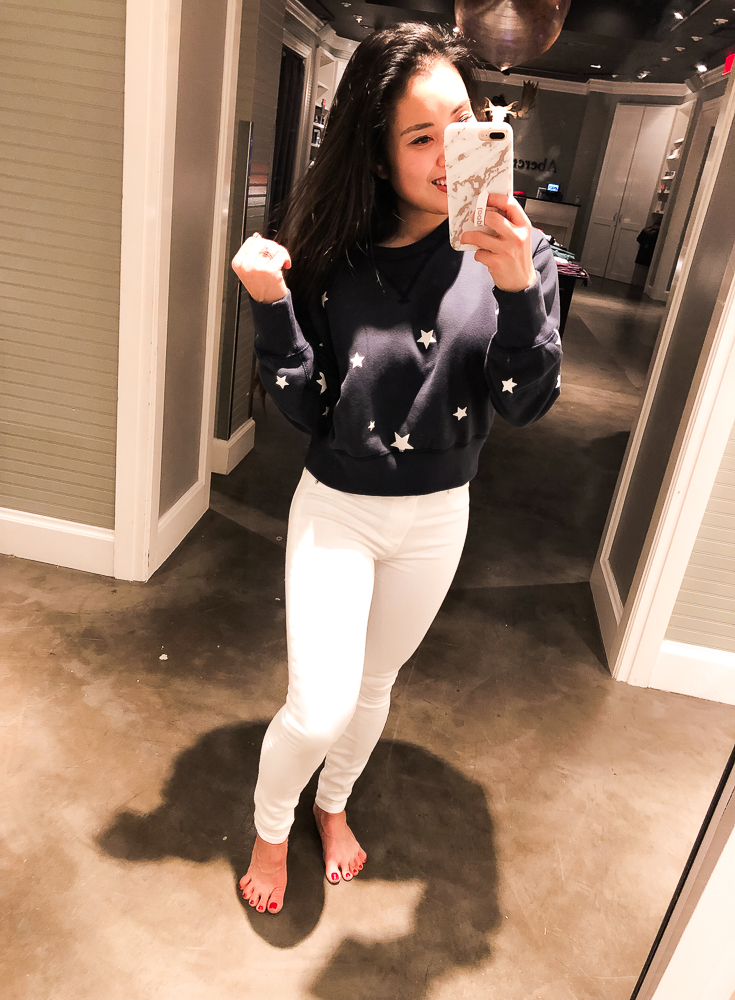 Abercrombie Try-On featured by top US fashion blog Cute & Little; Image of a woman wearing Abercrombie Cropped Crew Neck Sweatshirt and Abercrombie High Rise Super Skinny White Jeans.