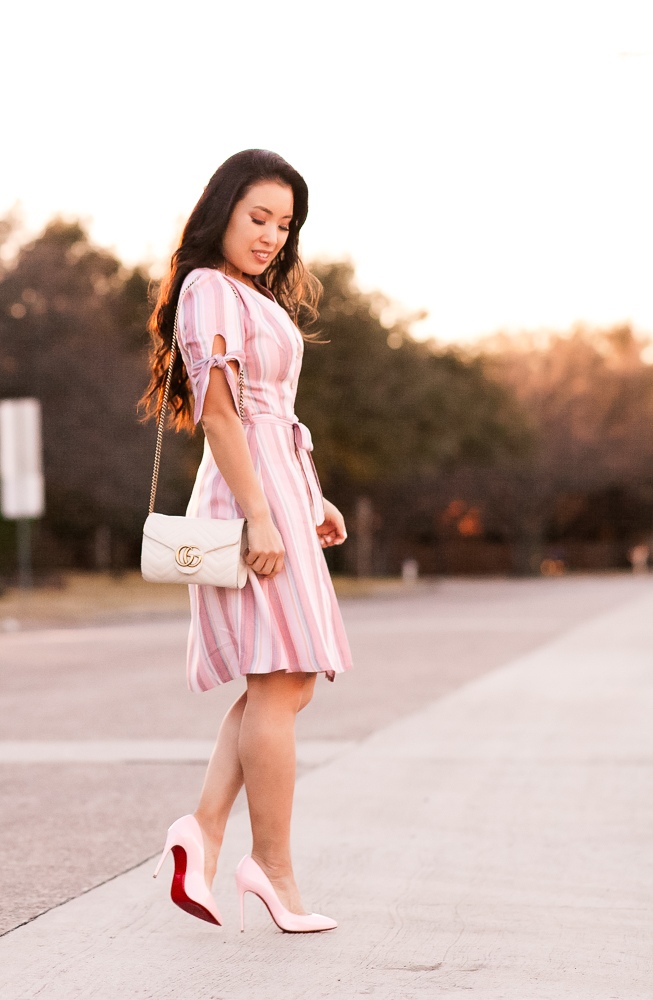 Valentine's Day Dress featured by top US fashion blog Cute & Little; Image of a woman wearing  Express Striped Button Dress, Express Layered Pave Charm Necklace, Louboutin 'Pigalle Follies' Pink Pumps, Baublebar 'Azalea' Flower Studs, Gucci Marmont Crossbody bag.