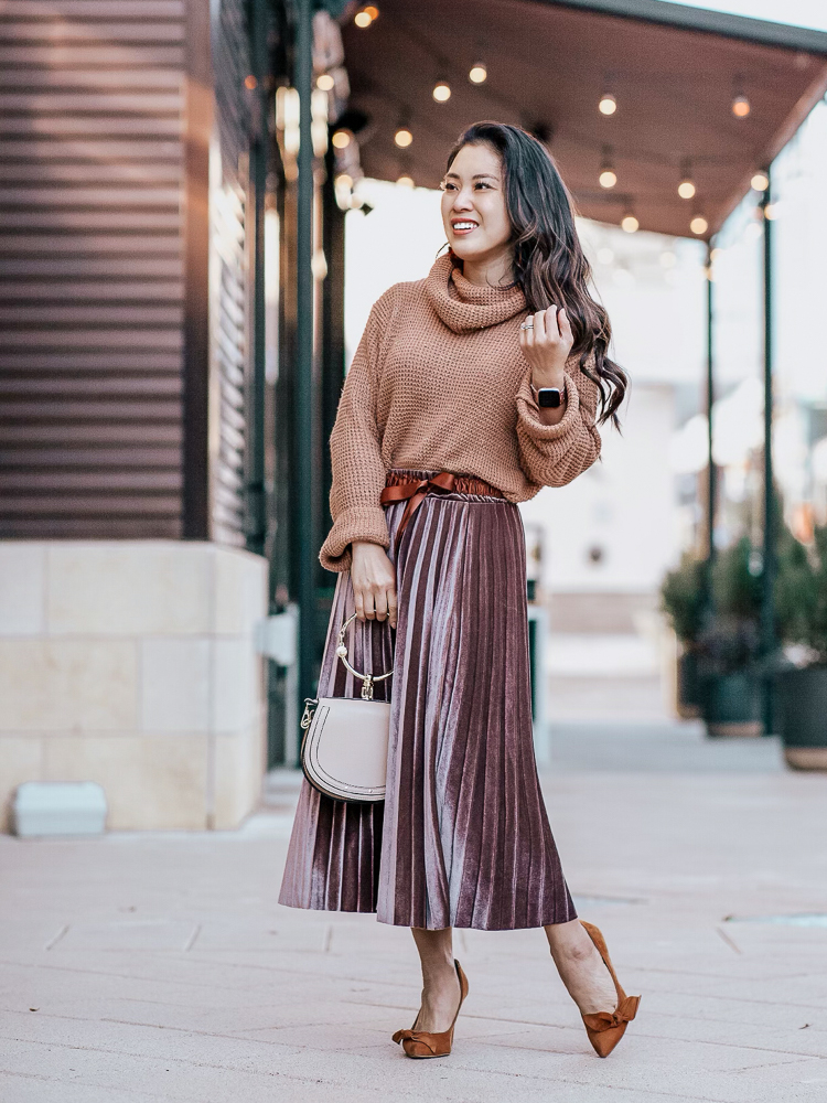 Spring Favorites featured by top US petite fashion blog Cute & Little; Image of a woman wearing Amazon Waffle Sweater, SheIn Knot Front Pleated Velvet skirt, Sole Society shoes, Amazon Bracelet Crossbody bag, Baublebar 'Faidra' Resin Drops earrins in tortoise.