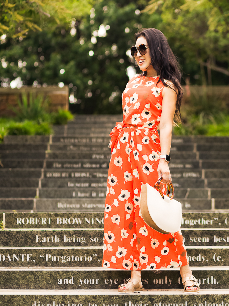 Spring Favorites featured by top US petite fashion blog Cute & Little; Image of a woman wearing shein red orange flower print crop jumpsuit and gold birkenstock sandals.
