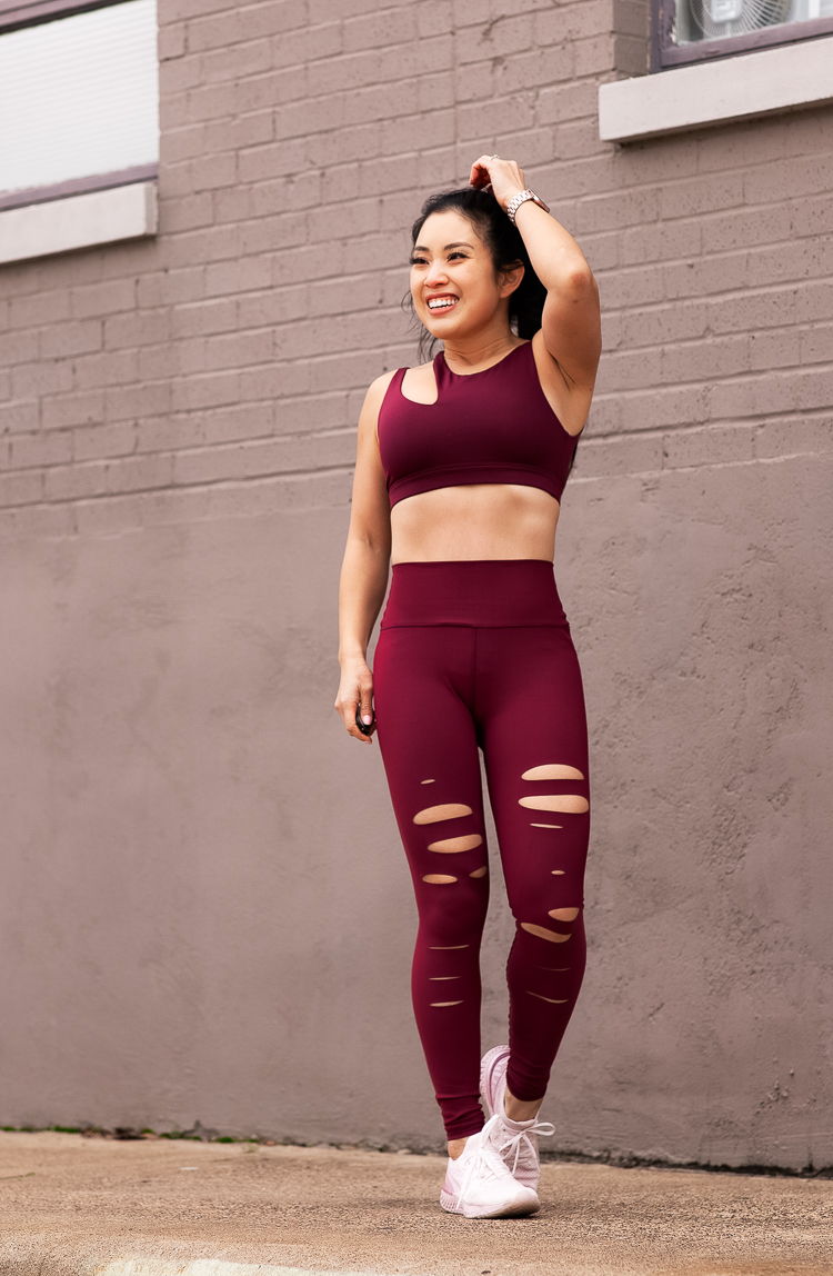 FASTer Way To Fat Loss featured by top US life and style blog Cute & Little; Image of a woman wearing an Alo Yoga Peak Bra, Alo Yoga High-Waist Ripped Warrior, Nike Epic React Flyknit Running Shoes and Fitbit ‘Versa’ watch.