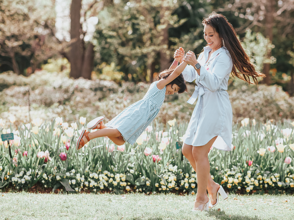 cute & little | dallas popular mom fashion blog | easter family outfit ideas | spring matching family mommy and me photoshoot outfit ideas | Easy Easter Outfit Ideas For The Family featured by top US fashion blog, Cute & Little; image of a woman wearing an Amazon blue stripe embroidered dress, White Mules shoes, and Gas Bijous 'Celeste' earrings and a girl wearing an Alice + Ames dress