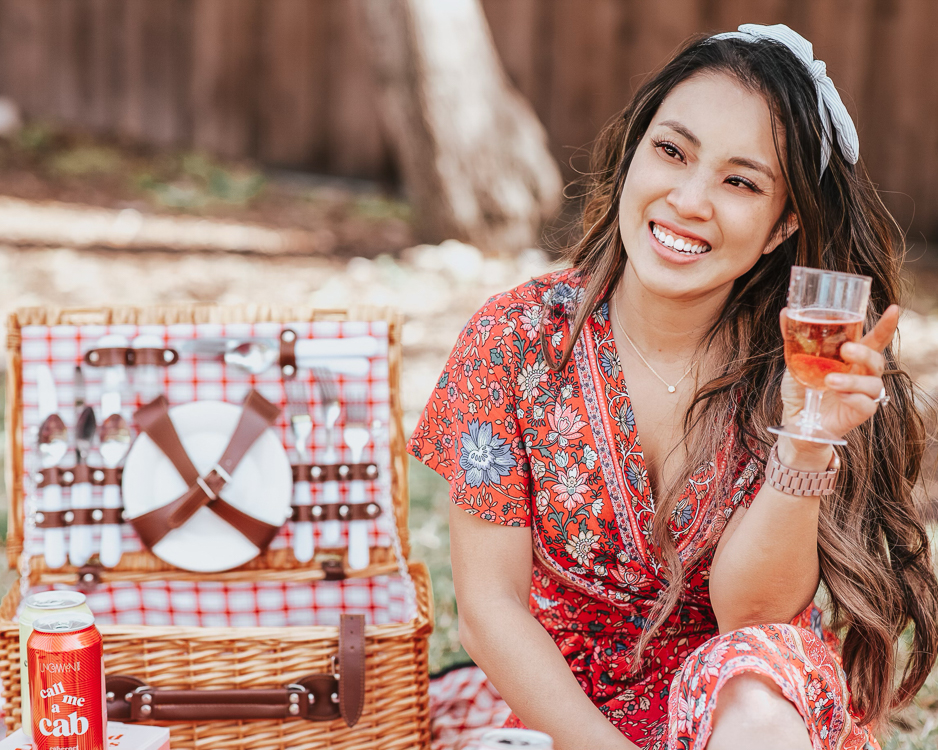 What to Wear to a Picnic featured by top US petite fashion blog Cute & Little; Image of a woman wearing Amazon Boho Floral Wrap Dress in red, Amazon Bow Knotted Headband, Brixton 'Joanna' Straw Hat and Steve Madden 'Greece' Slides