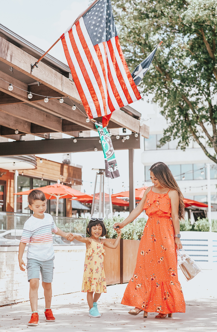 Memorial Day Outfits featured by top US fashion blog Cute & Little; Image of a woman and her kids wearing jcpenney peyton & parker mommy and me matching dresses and jcpenney boy's striped shirt and shorts.