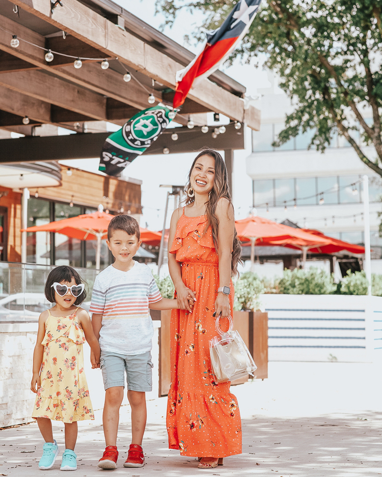 Memorial Day Outfits featured by top US fashion blog Cute & Little; Image of a woman and her kids wearing jcpenney peyton & parker mommy and me matching dresses and jcpenney boy's striped shirt and shorts.
