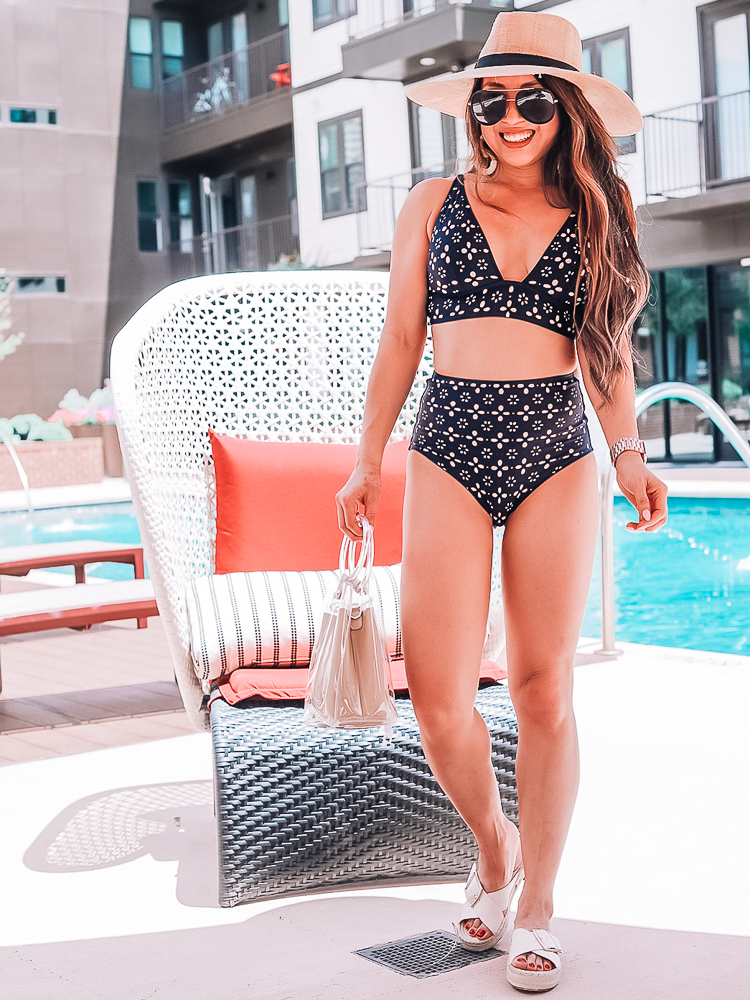 Swimsuits For Everyone featured by top US fashion blog Cute & Little; Image of a woman wearing j.crew laser-cut navy eyelet bikini, j.crew buckle cross strap espadrille sandal, straw hat, quay fame sunglasses and amazon clear tote.