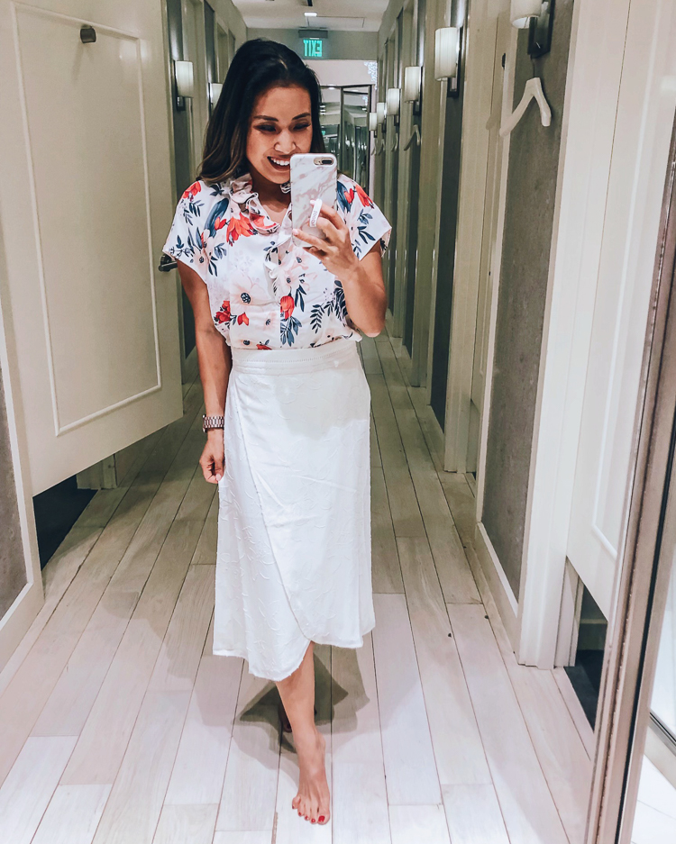 Ann Taylor Flash Sale featured by top US fashion blog Cute & Little; Image of a woman wearing ann taylor floral cluster double ruffle popover and ann taylor floral clip jacquard wrap skirt.