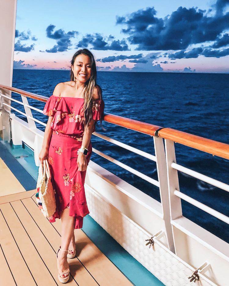 First Time Cruise Tips featured by top US travel blog Cute & Little; image of a woman wearing jcpenney pink floral off shoulder dress set and Steve Madden wedges.