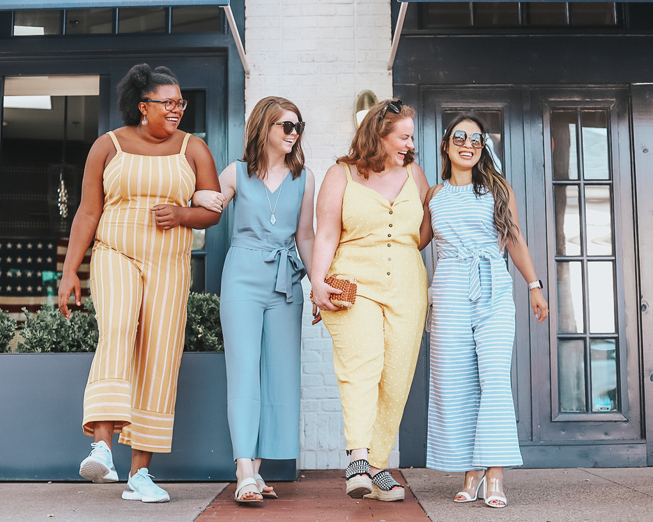 cute & little | popular dallas fashion blog | style for every body jumpsuits | summer outfit | Style For Every Body: Cute Summer Jumpsuits by popular Dallas petite fashion blog, Cute and Little: image of four women standing next to each other outside with arms linked and wearing yellow and white stripe Target women's striped strap square front knit jumpsuit Xhilaration, blue Everlane The Japanese GoWeave Essential Jumpsuit, yellow and white polka dot Modcloth jumpsuit, and PRETTYGARDEN 2019 Women's Striped Sleeveless Waist Belted Zipper Back Wide Leg Loose Jumpsuit Romper with Pockets.