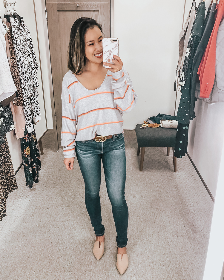 cute & little | dallas popular petite fashion blog | nordstrom anniversary sale 2019 dressing room try-on | free people make you mine stripe sweater, ag farrah skinny jeans | best of 2019 nsale | Nordstrom Anniversary Sale Try-On by popular Dallas petite fashion blog, Cute and Little: image of a woman in a Nordstrom dressing room wearing a Free People Make You Mine Sweater.