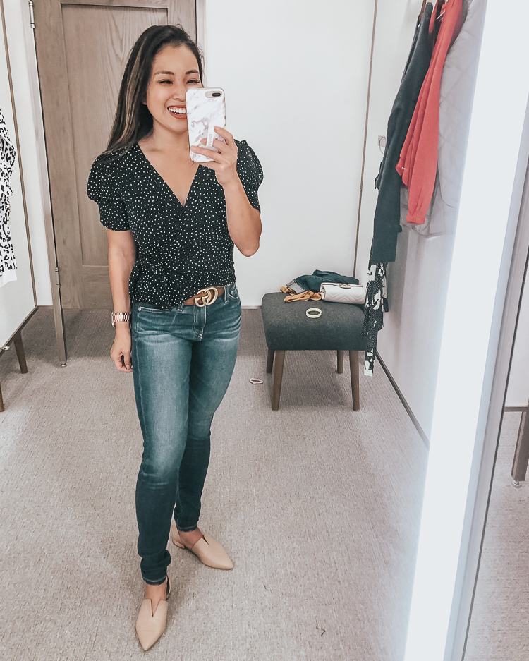 cute & little | dallas popular petite fashion blog | nordstrom anniversary sale 2019 dressing room try-on | all in favor black polka dot wrap top, ag farrah skinny jeans | best of 2019 nsale | Nordstrom Anniversary Sale Try-On by popular Dallas petite fashion blog, Cute and Little: image of a woman in a Nordstrom dressing room wearing a All In Favor Polka Dot Wrap Top.