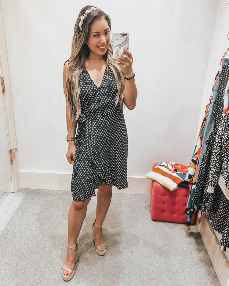 cute & little | popular dallas fashion blog | evereve august summer 2019 try-on | sanctuary wrap dress | Evereve Summer Collection 2019 Try-On by popular Dallas fashion blog, Cute and Little: image of a woman in a dressing room trying on a Evereve sanctuary wrap dress, Steve Madden 'Survive' Espadrilles, The Sis Kiss Name Necklace, Deepa Gurnani ‘Blessie’ Headband, Huda Beauty Liquid Matte Lipstick, and holding a Loopy Cases Loopy MAX - iPhone 6/7/8 PLUS.