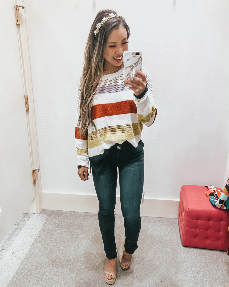 cute & little | popular dallas fashion blog | evereve august summer 2019 try-on | fate multi stripe pullover sweater, kut from the kloth mia high rise skinny jeans | Evereve Summer Collection 2019 Try-On by popular Dallas fashion blog, Cute and Little: image of a woman in a dressing room trying on Evereve fate multi stripe pullover sweater and kut from the kloth mia high rise skinny jeans.