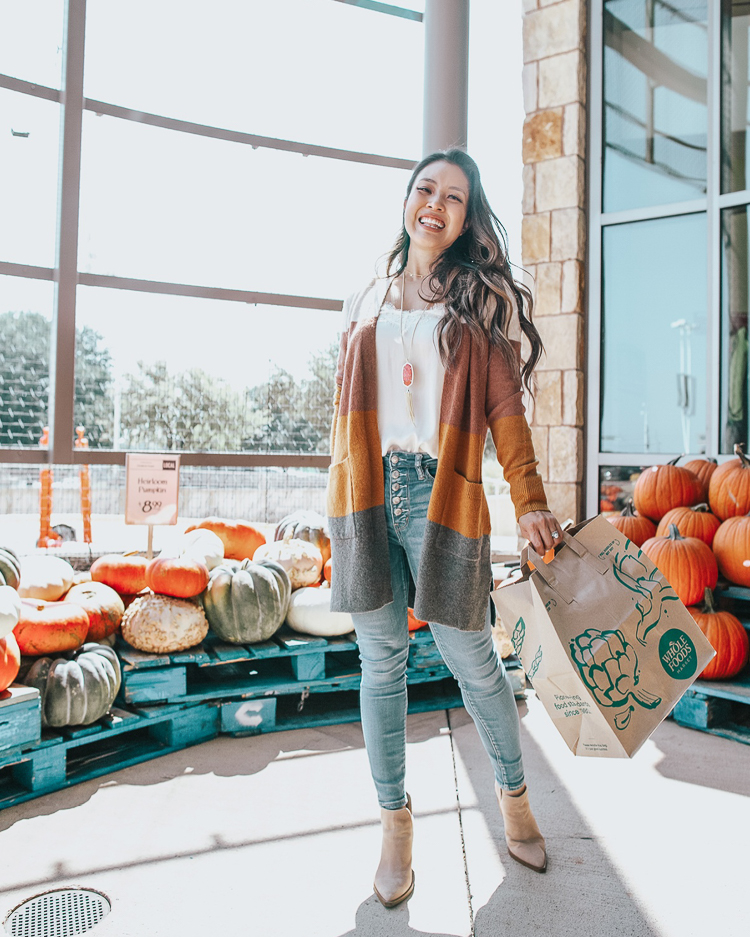 cute & little | popular dallas fashion lifestyle blog | whole foods market fall pumpkin spice | Pumpkin, Spice, and All Things Nice: Whole Foods Market Fall Products by popular Dallas life and style blog, Cute and Little: image of a woman outside of a Whole Foods market and wearing a Madewell Kent Striped Cardigan Sweater in Coziest Yarn, Nordstrom BP Lace Trim Satin Camisole Top, AE NE(X)T LEVEL SUPER HIGH-WAISTED JEGGING, Nordstrom Vince Camuto Gigietta Bootie, and Rayne Long Pendant Necklace In Gold.
