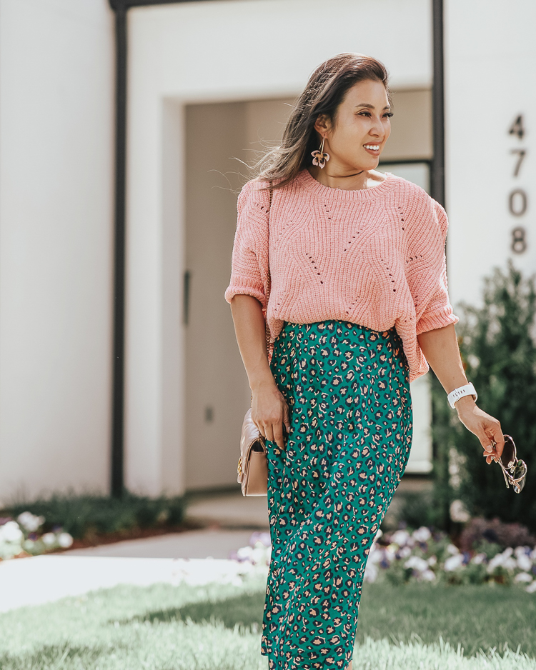 cute & little | popular dallas fashion blog | green animal print leopard midi skirt, pink ribbed chenille sweater, pink bow pumps | summer fall work office outfit | A Green Take On The Animal Print Midi Skirt by popular Dallas petite fashion blog, Cute and Little: image of a woman standing outside and wearing a Forever 21 Ribbed Chenille-Knit Sweater, Nordstrom Pamela Print Bias Cut Midi Skirt, Amazon SCHUTZ Women's Blasiana Pump, Nordstrom Baublebar Orchid Drop Earrings, Amazon Beatfull Bee Shoulder Bag for Women, Target Fitbit Versa Lite Smartwatch, and Gucci 63mm Open Temple Sunglasses.