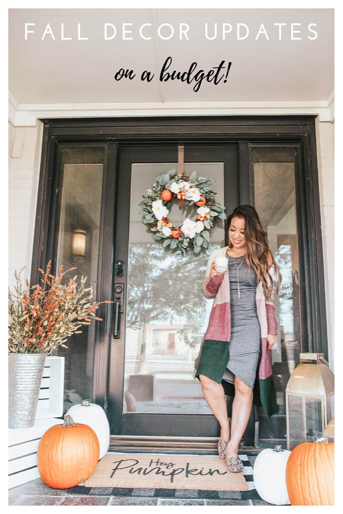 cute & little | popular dallas petite fashion lifestyle blog | how to decorate for fall on a budget | How to Get Beautiful Fall Home Decor on a Budget by popular Dallas life and style blog, Cute and Little: image of a woman holding a Trapp candle and standing out on her porch that's decorated with a Etsy Hey Pumpkin Doormat, Amazon Checkmate Cotton Buffalo Plaid Rugs Black and White Checkered Rug, Michaels Wood Crate Carry All by ArtMinds, Michaels 13" Cream Craft Pumpkin by Ashland, Michael's faux flowers, Michaels 16" Metal Whitewashed French Bucket by Ashland, and Target Metal Lantern in gold. 