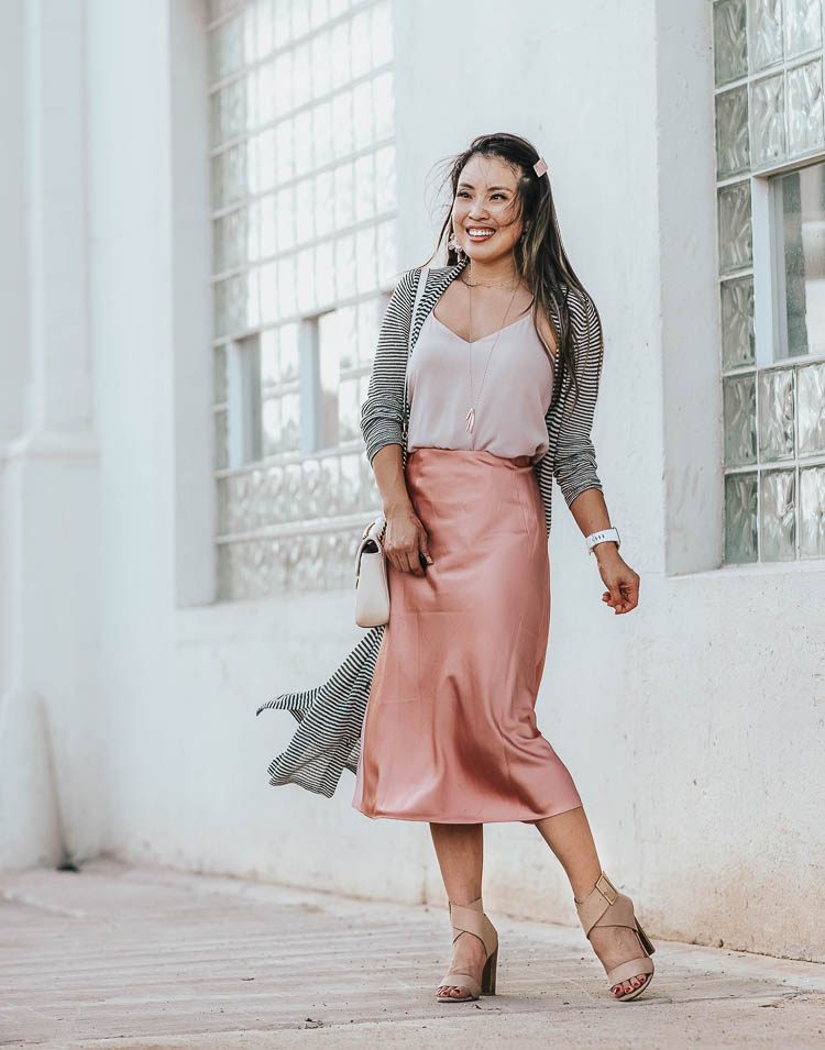 Silk slip skirt midi style for Fall by top US petite fashion blog, cute & little: image of a woman wearing a JCrew silk slip midi skirt, LOFT striped cardigan, Express Cami, Splendid Jayla shoes. | cute & little | dallas petite fashion blog | loft striped long duster cardigan, blush pink silk slip midi skirt | work office business casual outfit