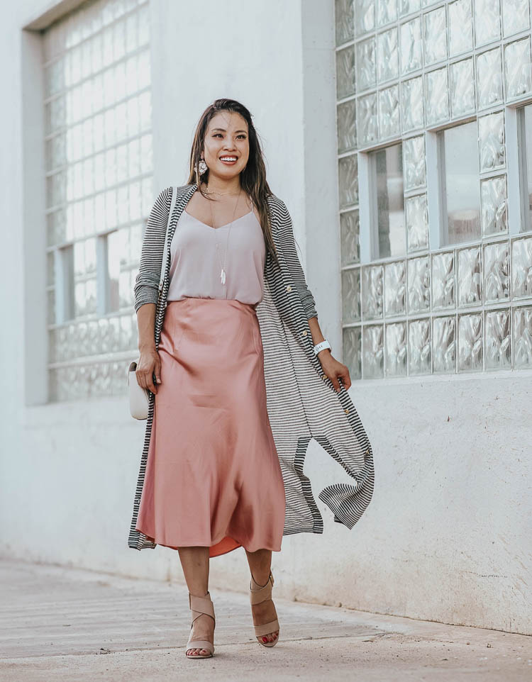 Silk slip skirt midi style for Fall by top US petite fashion blog, cute & little: image of a woman wearing a JCrew silk slip midi skirt, LOFT striped cardigan, Express Cami, Splendid Jayla shoes. | cute & little | dallas petite fashion blog | loft striped long duster cardigan, blush pink silk slip midi skirt | work office business casual outfit