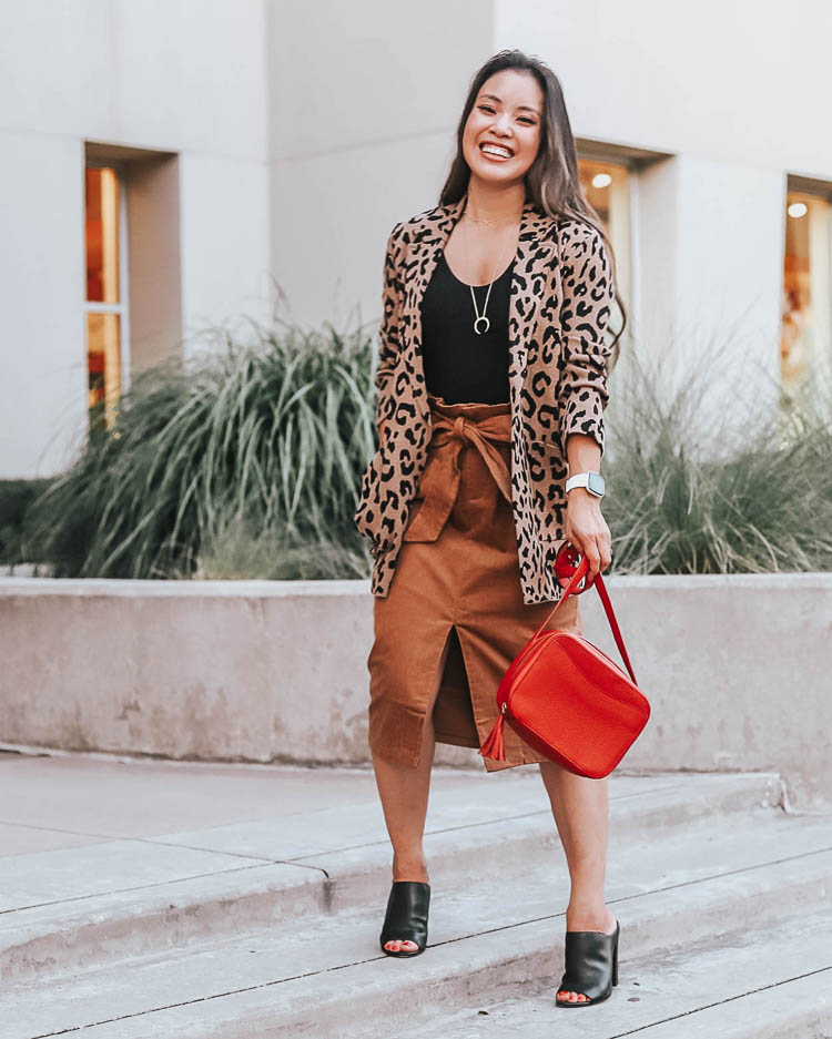 How to wear a Fall Blazer, styling tips featured by top US fashion blog, cute & little: image of a woman wearing a J.Crew leopard sweater blazer. | cute & little blog | popular dallas petite fashion blog | style for every body | body positivity | how to style blazer work business casual outfit | j.crew sophie leopard sweater blazer, black bodysuit, morning lavender linda corduroy midi skirt, cuyana red tassel bag