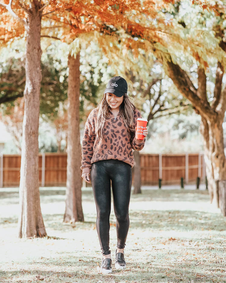 cute & little | dallas petite fashion blog | target grayson threads leopard fleece sherpa pullover, spanx black faux leather leggings | fall casual mom outfit | Fall ShopBop Sale: Up To 25% Off Everything!! by popular Dallas petite fashion blog, Cute and Little: image of a woman outside wearing a Target Grayson Threads Women's Leopard Print Long Sleeve 1/4 Zip Sherpa Sweatshirt, ShopBop SPANX Faux Leather Leggings, Zappos Steve Madden Steve Madden Gills Sneaker, and holding an Etsy Starbucks Reusable Cold Cup Venti. 