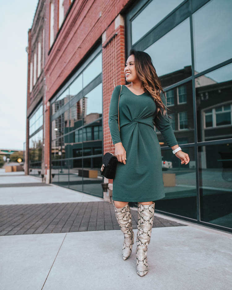 cute & little blog | dallas petite fashion blog | amazon work business casual fall dress, sam edelman hai knee high snakeskin boots | how to wear snakeskin boots | How To Wear Snakeskin Boots by popular Dallas petite fashion blog, Cute and Little: image of a woman in front of brick building and wearing a Lark & Ro Women’s Crepe Knit Three Quarter Sleeve Center Twist Dress, Sam Edelman Hai Knee High Boot, Amazon CUIL Quilted Purse Gold Metal Letters Shoulder Bag, ShopBop Madewell Medium Chunky Hoop Earrings, Fitbit Versa, and has her hair curled with a Ulta SinglePass Curl Professional Ceramic Curling Iron. 