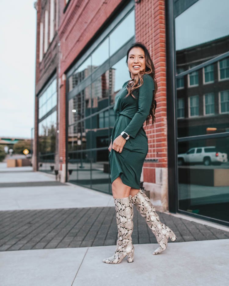 cute & little blog | dallas petite fashion blog | amazon work business casual fall dress, sam edelman hai knee high snakeskin boots | how to wear snakeskin boots | How To Wear Snakeskin Boots by popular Dallas petite fashion blog, Cute and Little: image of a woman in front of brick building and wearing a Lark & Ro Women’s Crepe Knit Three Quarter Sleeve Center Twist Dress, Sam Edelman Hai Knee High Boot, Amazon CUIL Quilted Purse Gold Metal Letters Shoulder Bag, ShopBop Madewell Medium Chunky Hoop Earrings, Fitbit Versa, and has her hair curled with a Ulta SinglePass Curl Professional Ceramic Curling Iron. 