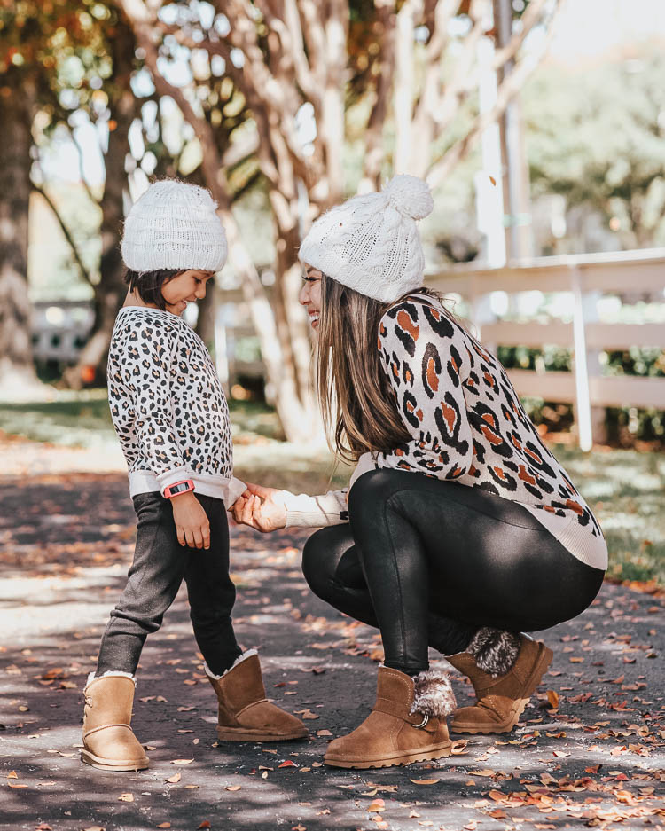 cute & little | popular dallas petite fashion blog | target leopard sweater, spanx black faux leather legging, toddler girl leopard sweater, bearpaw koko ugg boots, bearpaw rosie boots | fall winter matching mommy daughter outfit | Mommy and Me Matching Outfits: Leopard and Bearpaw Boots by Dallas petite fashion blog, Cute and Little: image of a mom and daughter outside playing in the leaves in wearing Target A New Day Women's Leopard Print Long Sleeve Rib-Knit Cuff Crewneck Pullover Sweater, Nordstrom Spanx Faux Leather Leggings, DSW KOKO BOOTIE, Aerie LEMON WINTER CABIN POM BEANIE, Nordstrom Tucker and Tate TUCKER + TATE Sparkle Leopard Spot Sweatshirt, Main, color, IVORY EGRET SNOW LEOPARD DETAILS & CARE This sweatshirt will be the one she chooses most often on school days, thanks to the combination of pink sparkles and leopard spots. 58% cotton, 37% polyester, 5% spandex Machine wash, tumble dry Imported Kids' Wear Item #5874206 Free Shipping & Returns See more Sparkle Leopard Spot Sweatshirt, Target Cat & Jack Toddler Girls' Leggings, and DSW kids KOKO BOOT.
