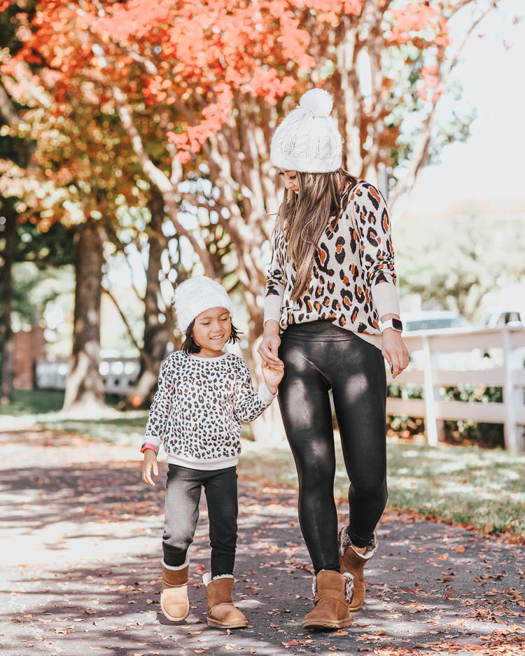 cute & little | popular dallas petite fashion blog | target leopard sweater, spanx black faux leather legging, toddler girl leopard sweater, bearpaw koko ugg boots, bearpaw rosie boots | fall winter matching mommy daughter outfit | Mommy and Me Matching Outfits: Leopard and Bearpaw Boots by Dallas petite fashion blog, Cute and Little: image of a mom and daughter outside playing in the leaves in wearing Target A New Day Women's Leopard Print Long Sleeve Rib-Knit Cuff Crewneck Pullover Sweater, Nordstrom Spanx Faux Leather Leggings, DSW KOKO BOOTIE, Aerie LEMON WINTER CABIN POM BEANIE, Nordstrom Tucker and Tate TUCKER + TATE Sparkle Leopard Spot Sweatshirt, Main, color, IVORY EGRET SNOW LEOPARD DETAILS & CARE This sweatshirt will be the one she chooses most often on school days, thanks to the combination of pink sparkles and leopard spots. 58% cotton, 37% polyester, 5% spandex Machine wash, tumble dry Imported Kids' Wear Item #5874206 Free Shipping & Returns See more Sparkle Leopard Spot Sweatshirt, Target Cat & Jack Toddler Girls' Leggings, and DSW kids KOKO BOOT.