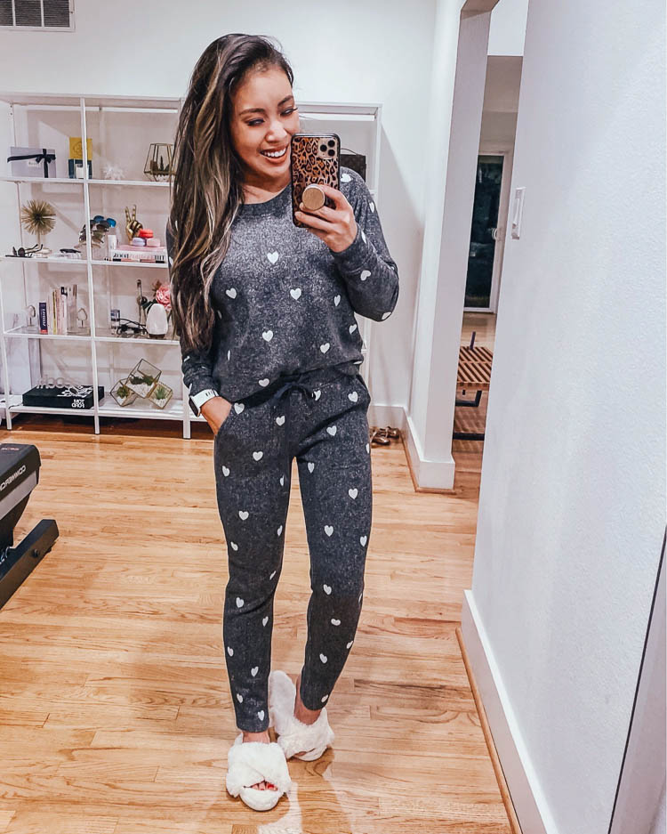 LOFT Fall Try On featured by top US petite fashion blog, cute & little: image of a woman wearing a LOFT love heart sweatshirt and joggers. cute & little | dallas petite fashion blog | heart grey sweatshirt sweatpants pajamas set