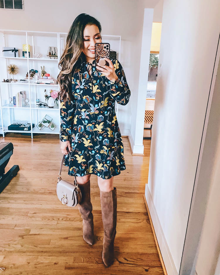 LOFT Fall Try On featured by top US petite fashion blog, cute & little: image of a woman wearing a LOFT floral tie neck dress. cute & little | dallas petite fashion blog | work business casual dress | fall outfit | loft navy floral dress, suede knee-high boots 