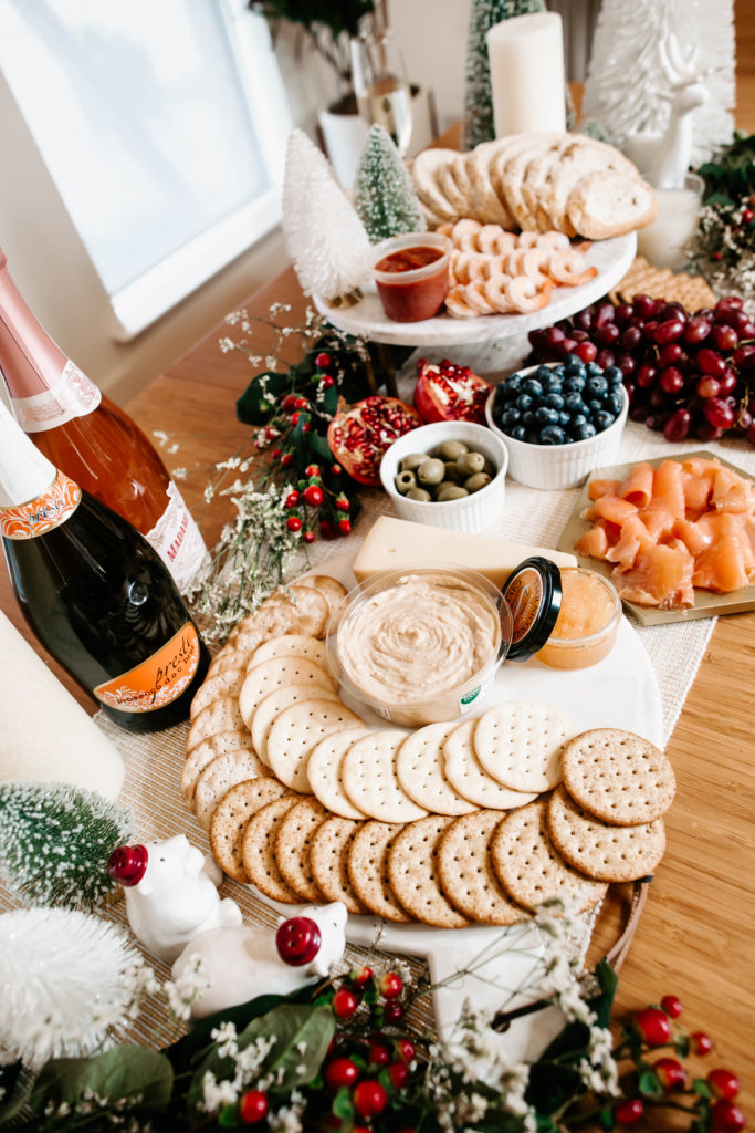 cute & little | dallas mom lifestyle blog | how to throw no-cook holiday new years party whole foods affordable | grazing table charcuterie board | How-To Throw Holiday Party with No Cook Appetizers by popular Dallas life and style blog, Cute and Little: image of Whole Foods Tsar Nicoulai, Whitefish Roe American Golden, Whole Foods 365 Everyday Value, Assorted Entertainment Crackers, Whole Foods Hummus Original, Whole Foods Kitchen's Seafood Shrimp Cocktail Tail-on Shrimp w/ Cocktail Sauce, Whole Foods Bread Loaf Seeduction, Whole Foods Santa Barbara Smokehouse, Smoked Atlantic Salmon, and Whole Foods Divina, Olives Casetelvetrano Organic.