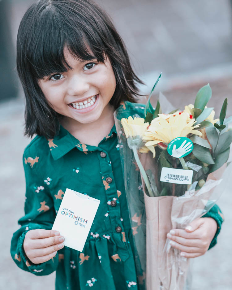 cute & little | dallas mom lifestyle blog | spread joy through the holidays | random acts of kindness with kids | 12 Easy Ways to Spread Joy This Holiday by popular Dallas life and style blog, Cute and Little: image of a little girl holding a bouquet of flowers.