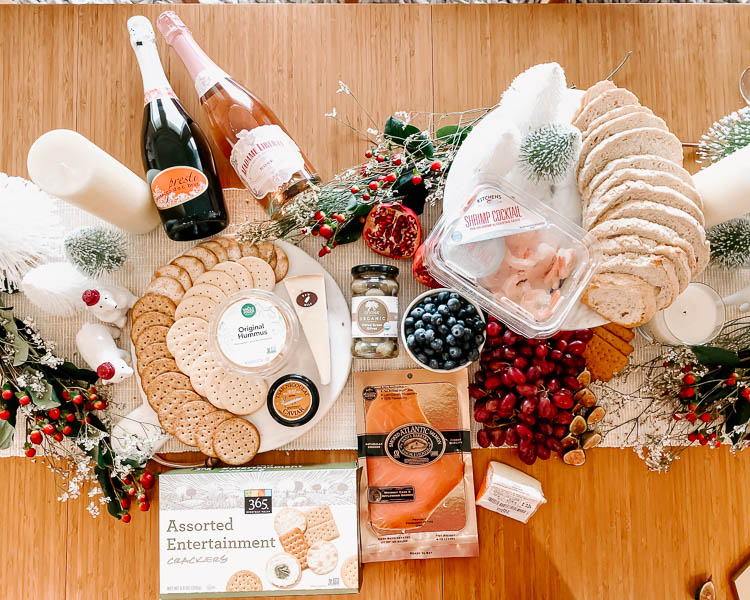 cute & little | dallas mom lifestyle blog | how to throw no-cook holiday new years party whole foods affordable | grazing table charcuterie board | How-To Throw Holiday Party with No Cook Appetizers by popular Dallas life and style blog, Cute and Little: image of Whole Foods Tsar Nicoulai, Whitefish Roe American Golden, Whole Foods 365 Everyday Value, Assorted Entertainment Crackers, Whole Foods Hummus Original, Whole Foods Kitchen's Seafood Shrimp Cocktail Tail-on Shrimp w/ Cocktail Sauce, Whole Foods Bread Loaf Seeduction, Whole Foods Santa Barbara Smokehouse, Smoked Atlantic Salmon, and Whole Foods Divina, Olives Casetelvetrano Organic.