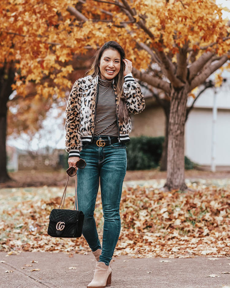 cute & little blog | dallas petite fashion blog | bb dakota cat power leopard faux fur jacket, j.crew striped tissue turtleneck, ae high waisted jeans | fall winter outfit | Top 10 Faux Fur Trend Items To Keep You Warm All Winter by popular Dallas petite fashion blog, Cute and Little: image of a woman outside wearing a Nordstrom Jack by BB Dakota Leopard Faux Fur Bomber Jacket, J. Crew Tissue turtleneck T-shirt in stripes, American Eagle AE NE(X)T LEVEL HIGHEST WAIST JEGGING, Gucci Leather Belt with GG Buckle, and Nordstrom Gigietta Bootie VINCE CAMUTO.