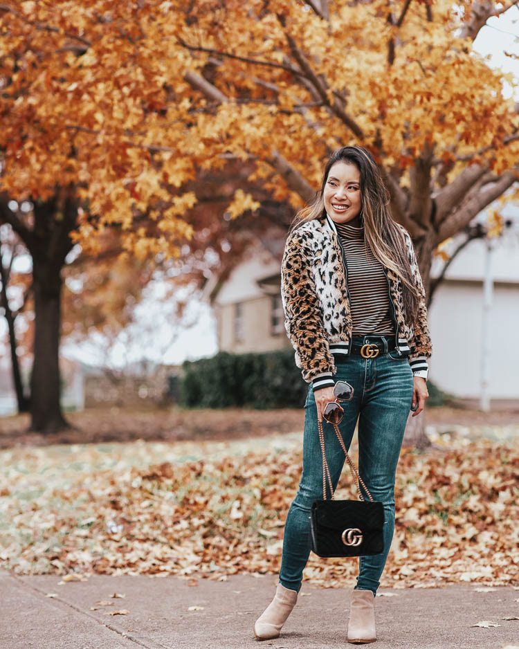 cute & little blog | dallas petite fashion blog | bb dakota cat power leopard faux fur jacket, j.crew striped tissue turtleneck, ae high waisted jeans | fall winter outfit | Top 10 Faux Fur Trend Items To Keep You Warm All Winter by popular Dallas petite fashion blog, Cute and Little: image of a woman outside wearing a Nordstrom Jack by BB Dakota Leopard Faux Fur Bomber Jacket, J. Crew Tissue turtleneck T-shirt in stripes, American Eagle AE NE(X)T LEVEL HIGHEST WAIST JEGGING, Gucci Leather Belt with GG Buckle, and Nordstrom Gigietta Bootie VINCE CAMUTO.