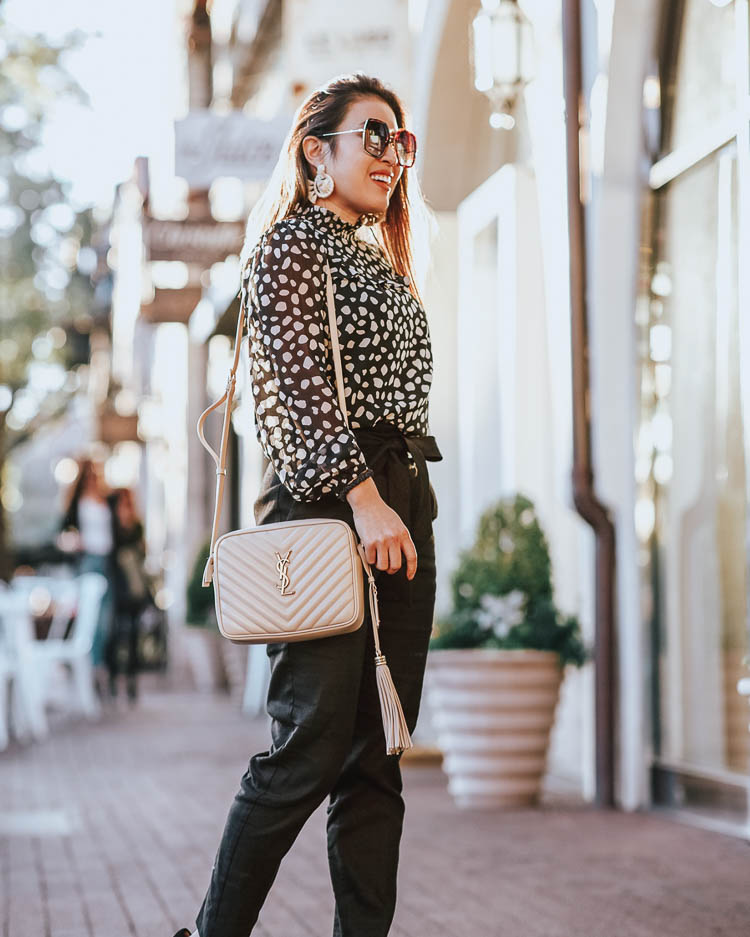 cute & little | dallas petite fashion blog | loft leopard blouse, express black high waisted trouser pants, ysl lou camera bag | spring work outfit | how to wear animal print to work | How-To Wear the Leopard Print Trend To The Office by popular Dallas petite fashion blog, Cute and Little: image of a woman wearing a J. Crew Classic lady day coat in Italian double-cloth wool with Thinsulate, Loft PETITE SPOTTED RUFFLE YOKE BLOUSE, Express High Waisted Plaid Sash Tie Ankle Pant, Sole Society black heel, Amazon BEST LADY Fashion Cute DIY Animal Beaded Earrings, Amazon Gucci GG 0106 S- 002 002 HAVANA, and Nordstrom Lou Matelassé Leather Camera Bag SAINT LAURENT.