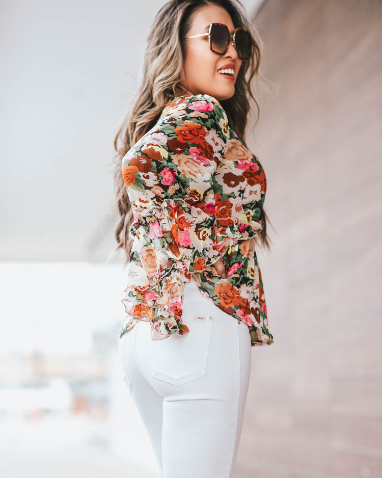 cute & little | dallas petite fashion blog | floral bell sleeve blouse, jen7 jeans | spring transition outfit | Spring Florals by popular Dallas petite fashion blog, Cute and Little: image of a woman wearing a SheIn SHEIN Floral Print Flounce Sleeve Peplum Top, JEN7 by 7 For All Mankind Cropped Skinny Jeans in White, Amazon Gucci GG 0106 S- 002 002 HAVANA / BROWN / GOLD Sunglasses, Just Fab white heels, and James Avery Mini Heart Charm.