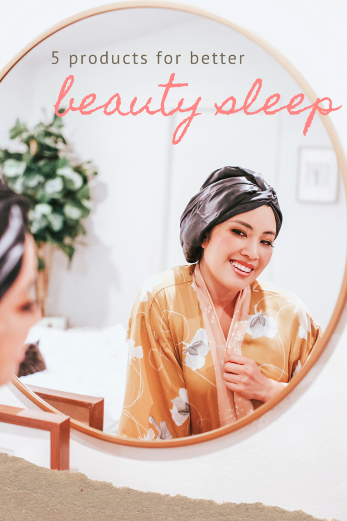 cute & little blog | 5 products for better beauty sleep | Beauty Sleep Products by popular Dallas beauty blog, Cute and Little: image of a woman wearing a silk head wrap, orange floral robe and looking at herself in a round mirror. 
