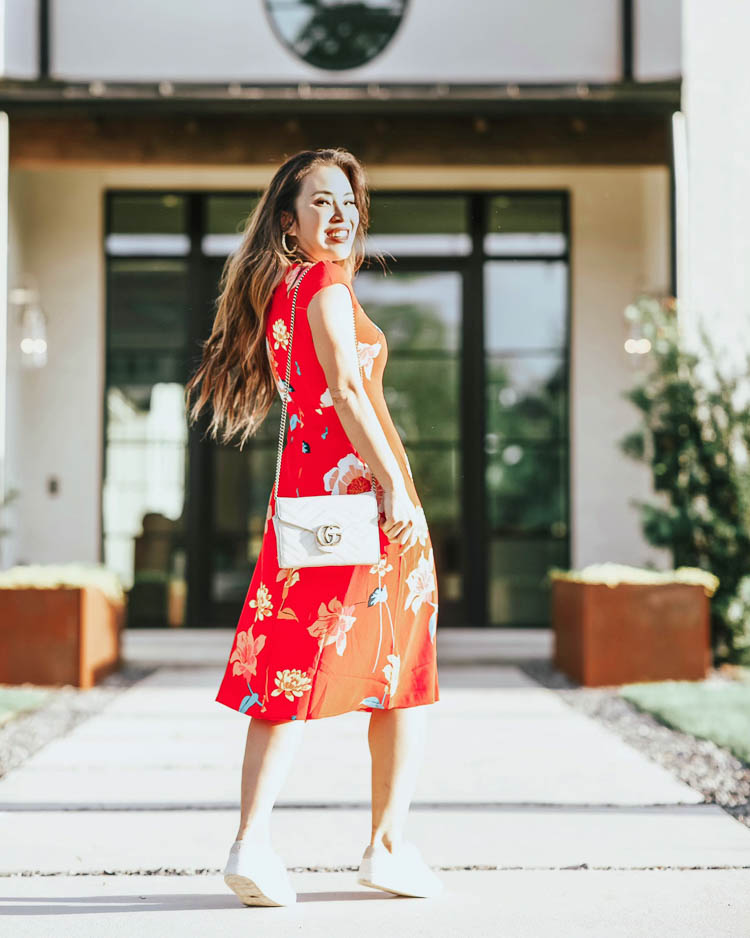 cute & little | dallas petite fashion blog | loft red floral midi dress, trask white lace-up sneakers | quarantine work office spring outfit | The Enneagram Test by popular Dallas lifestyle blog, Cute and Little: image of a woman wearing a Loft LILY CAP SLEEVE MIDI DRESS, Zappos Trask Lindsey sneakers, Target Fitbit Versa Lite Smartwatch, BaubleBar PITTI PISA HOOP EARRINGS, Gucci GG Marmont Matelassé Mini Bag, Sephora HUDA BEAUTY Liquid Matte Lipstick, and Ulta Kiss  Lash Couture Faux Mink, Soir.