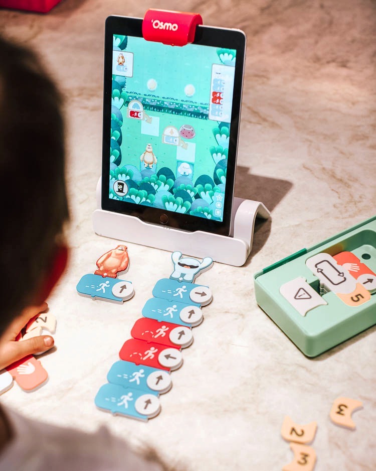 cute & little | stem education learning at home | osmo coding aubie review | Stem Games by popular Dallas lifestyle blog, Cute and Little: image of a little boy doing Osmo coding. 