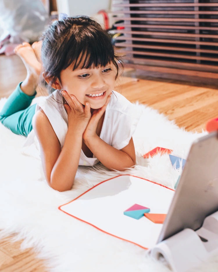 cute & little | stem education learning at home | osmo little genius tangrams review | Stem Games by popular Dallas lifestyle blog, Cute and Little: image of a little girl using a Osmo Little Genius Kit. 